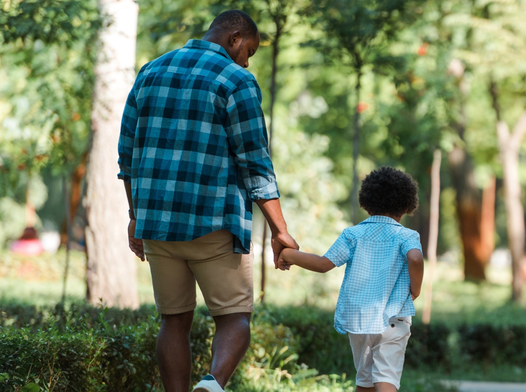 Father and child walking together in nature